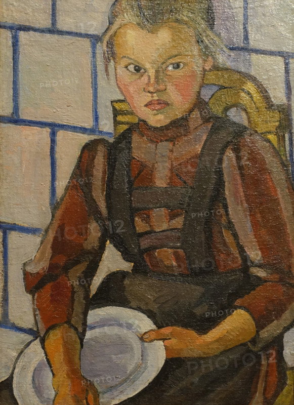 Portrait of a girl against a Tile Stove