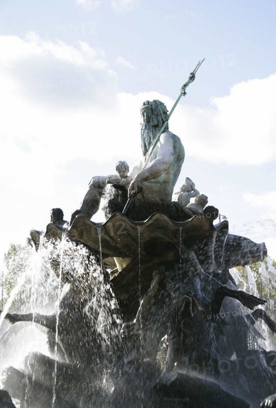 Berlin, Germany. Neptune Fountain (Neptunbrunnen). Designed by Reinhold Begas (1831-1911) and inaugurated in 1891, the fountain was moved from its original location at the Schlossplatz in 1951 when the former Berliner Schloss (Berlin Palace) there was demolished. After being restored, it was moved in 1969 to its present location between St. Mary's Church (Marienkirche) and the Red Town Hall (Rotes Rathaus). The Roman god Neptune is in the center. The four women around him represent the four main rivers of Prussia at the time of its construction: Elbe, Rhine, Vistula and Oder. Detail.