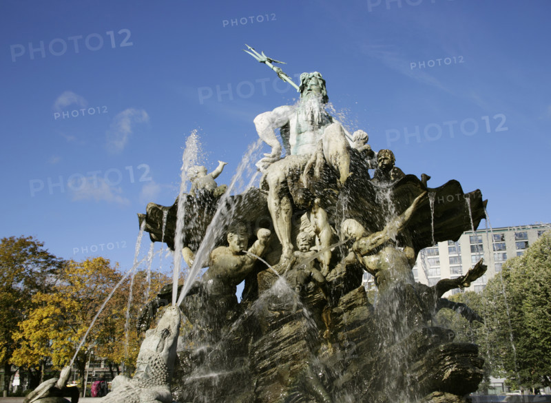 Berlin, Germany. Neptune Fountain (Neptunbrunnen). Designed by Reinhold Begas (1831-1911) and inaugurated in 1891, the fountain was moved from its original location at the Schlossplatz in 1951 when the former Berliner Schloss (Berlin Palace) there was demolished. After being restored, it was moved in 1969 to its present location between St. Mary's Church (Marienkirche) and the Red Town Hall (Rotes Rathaus). The Roman god Neptune is in the center. The four women around him represent the four main rivers of Prussia at the time of its construction: Elbe, Rhine, Vistula and Oder. Detail.