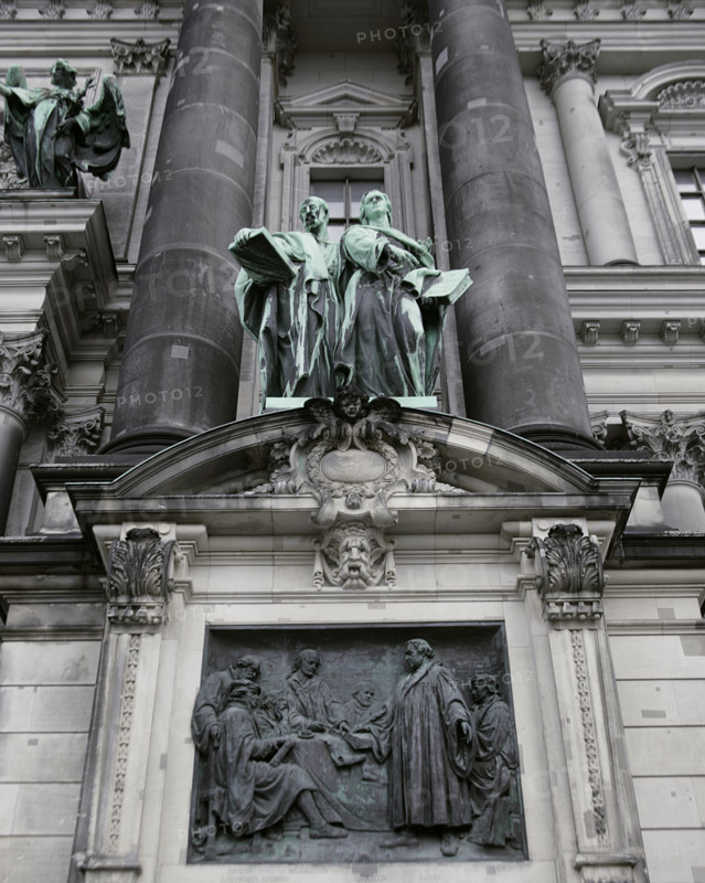 Germany. Berlin Cathedral (Berliner Dom). Temple inaugurated in 1905. It was built by order of Emperor Wilhelm II (1859-1941) between 1894 and 1905, under the direction of German architect Julius Carl Raschdorff (1823-1914). Also known as the Evangelical Supreme Parish and Collegiate Church, it is a monumental German Protestant church and dynastic tomb (House of Hohenzollern). Statues representing Saint Luke (left) and Saint John (right) on the main facade. Sculpted in copper by German sculptors Gerhard Janensch (1860-1933) and Johannes Gotz (1865-1934). Below, relief depicting Martin Luther (1483-1546) among the Reformers, by German sculptor Johannes Gotz (1865-1934), 1904.