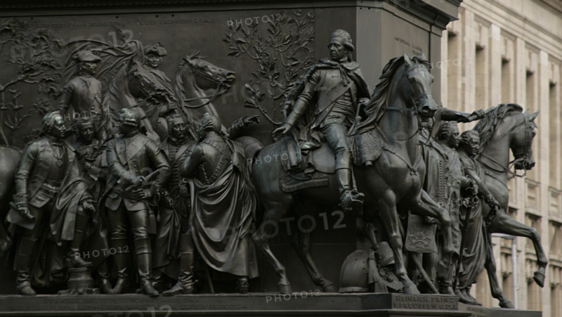 From left to right: Friedrich Leopold von Gessler (1688-1762), Prussian field marshal; Carl Heinrich von Wedel (1712-1782), Prussian General; Leopold II, Prince of Anhalt-Dessau (1700-1751) and Prussian General; Hartwig Karl von Wartenberg (1711-1757), Royal Prussian major general and Proprietor (Inhaber) of the Hussars Regiment No. 3; and Karl Christoph von der Goltz (1707-1761), Prussian lieutenant general. On horseback: Henry of Prussia (Frederick Henry Ludwig of Prussia) (1726-1802), Prince of Prussia. Detail from the monument to Frederick the Great, erected on Unter den Linden Avenue, Berlin, Germany. Made in bronze between 1839 and 1851 by German sculptor Christian Daniel Rauch (1777-1857).