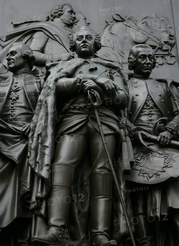 Augustus William of Prussia (August Wilhelm von Preussen) (1722-1758). Prince of Prussia. Brother and general of Frederick the Great. Relief figure depicting Augustus William (foreground). Left of the image: Prussian Major General Hans Sigismund von Lestwitz (1718-1788). Right: Heinrich Sigismund von der Heyde (1703-1765), Prussian commander-in-chief of the fortress of Kolberg. In his hands is a plan of Kolberg. Detail from from the monument to Frederick the Great, erected on Unter den Linden Avenue, Berlin, Germany. Made in bronze between 1839 and 1851 by German sculptor Christian Daniel Rauch (1777-1857).