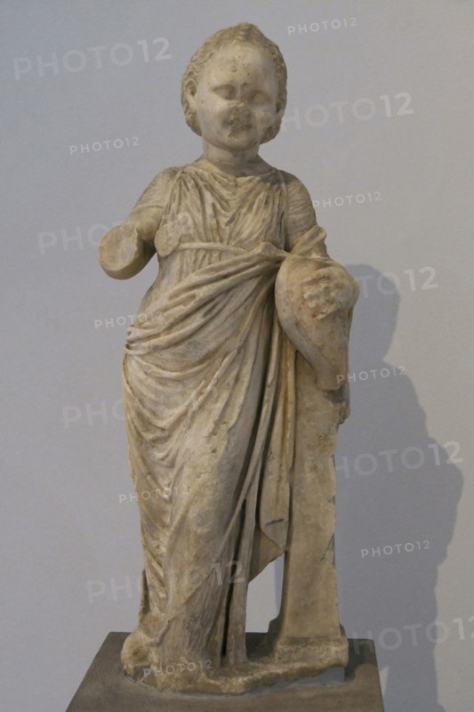 Statue of a little girl holding a goose; a common type of votive offering to ancient sanctuaries. Hellenistic period (323 BC-30 BC). Archaeological Museum of Piraeus. Greece.