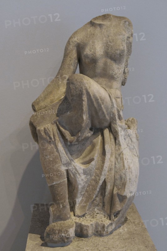 Statue of a nymph seated on a rock. For years it ornamented the facade of a neoclassical house in Piraeus. It is a Roman copy from the 2nd century AD of the sculptural ensemble called ""Invitation to the Dance"", example of the Rococo style of Hellenistic sculpture. Archaeological Museum of Piraeus. Greece.