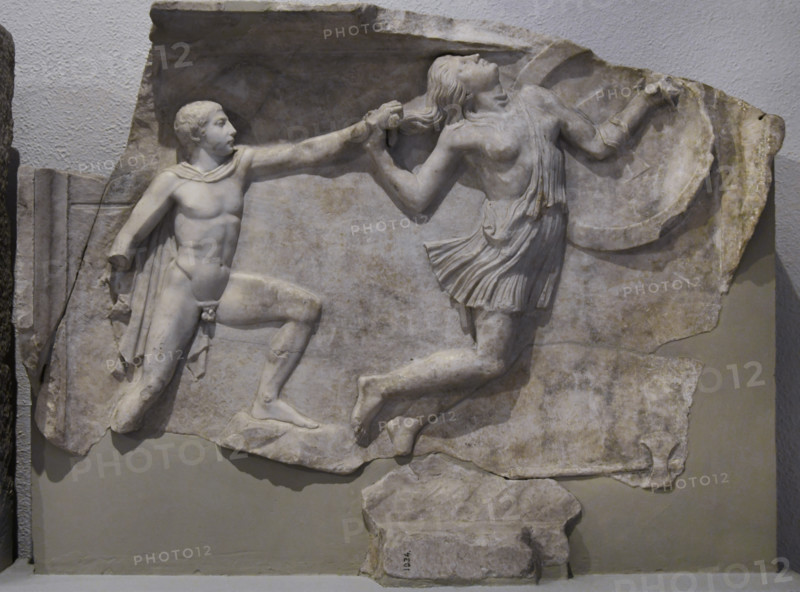 Relief depicting a Greek pursuing an Amazon. Marble. It is part of a pair of duplicate relief slabs, Roman copies made in an ancient Attic workshop in the mid-2nd century AD, depicting scenes from the shield of Athena on the Athena Parthenos statue by Phidias in the Parthenon. Found in the port of Piraeus, it was intended to decorate a building in Rome. Archaeological Museum of Piraeus. Greece.
