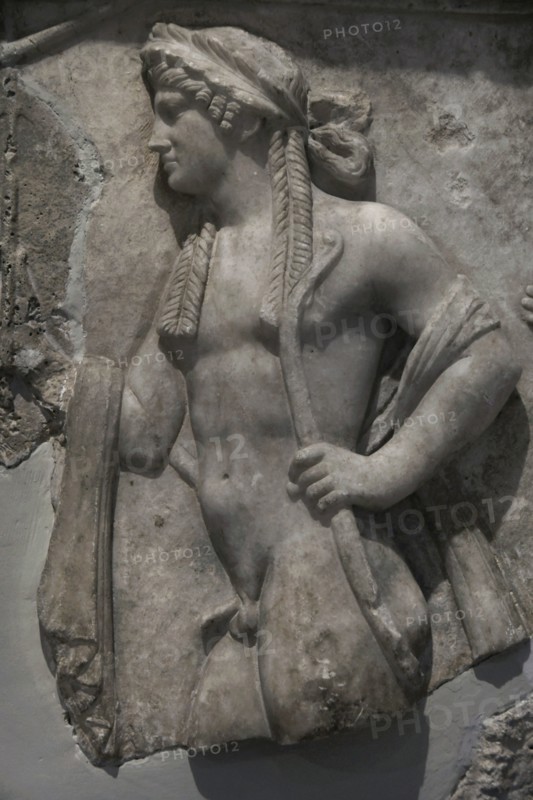 Relief slab depicting four deities in procession. Detail of Apollo. Marble. Archaeological Museum of Piraeus. Greece.