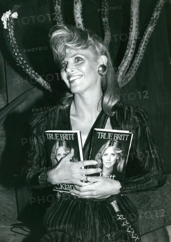 Britt Ekland holding two copies of her book ""True Britt"" at Starbucks Restaurant and Disco in New York