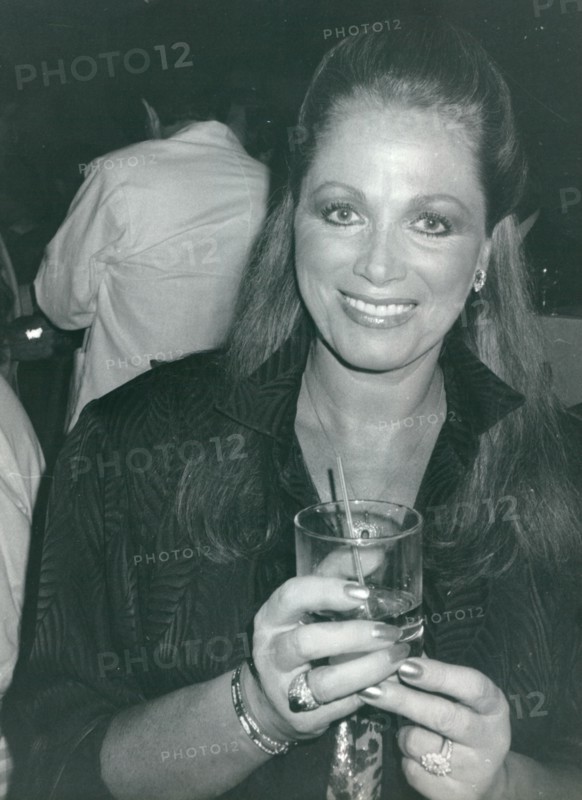 British author Jackie Collins with a drink