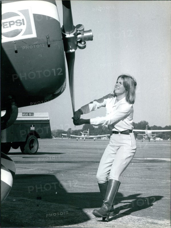 Pepsi Skywriter Susanne Asbury turning the propeller before taking off, circa 1980s