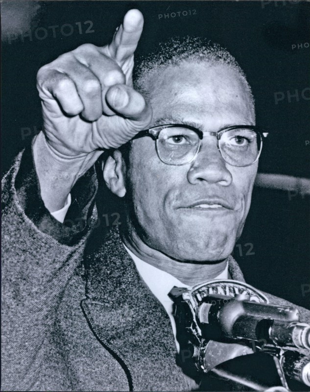 Malcolm X at microphone