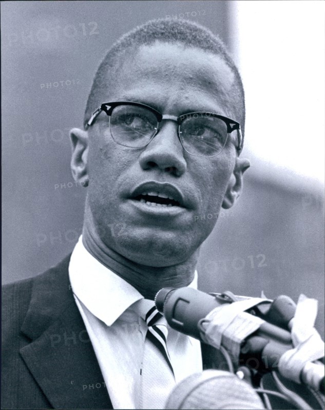 Malcolm X at microphone