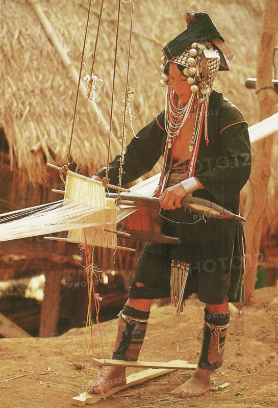 North of Thailand, Akha Hilltribe: A home-made loom is a handy apparatus to have around when weaving cloth needed by the whole family, 2005 circa