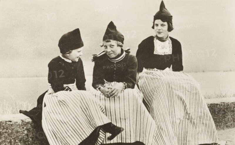 Three girls wearing The Netherlands typical costume