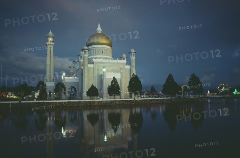 BRUNEI, Bandar Seri Begawan, "Omar Ali Saifuddin Mosque, exterior view reflected in water illuminated at dusk."
