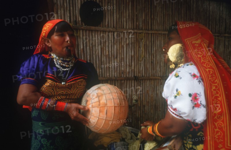 INDIA, San Blas Islands, Cuna Indian women washing clothes with one smoking a pipe