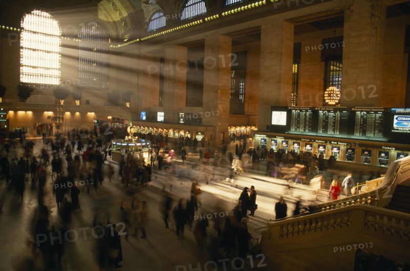 USA, New York State, New York, Grand Central station ticket hall at rush hour with light streaming through the windows