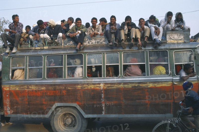 INDIA, Rajasthan, Fatehpur, Local bus crowded with people inside and on the roof