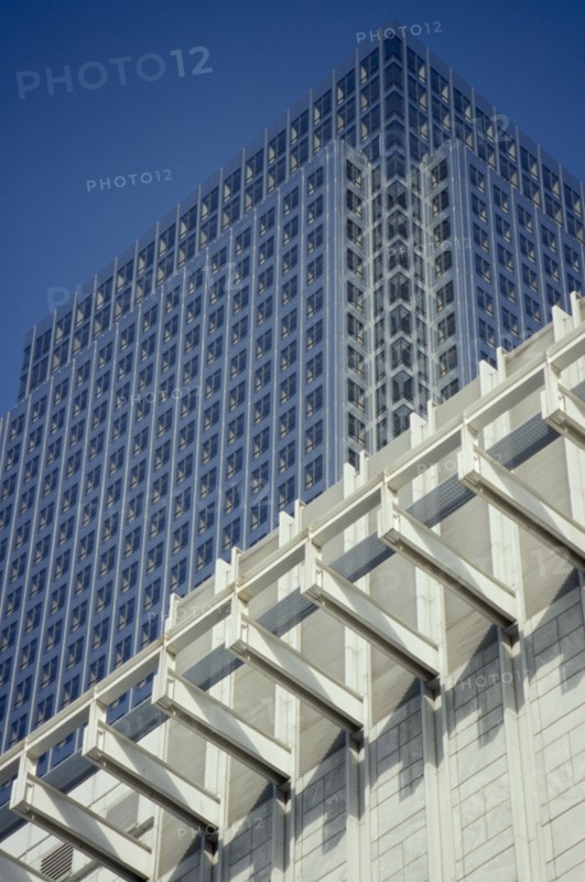 ENGLAND, London, Canary Wharf. Canada Tower rising over white building in the foreground