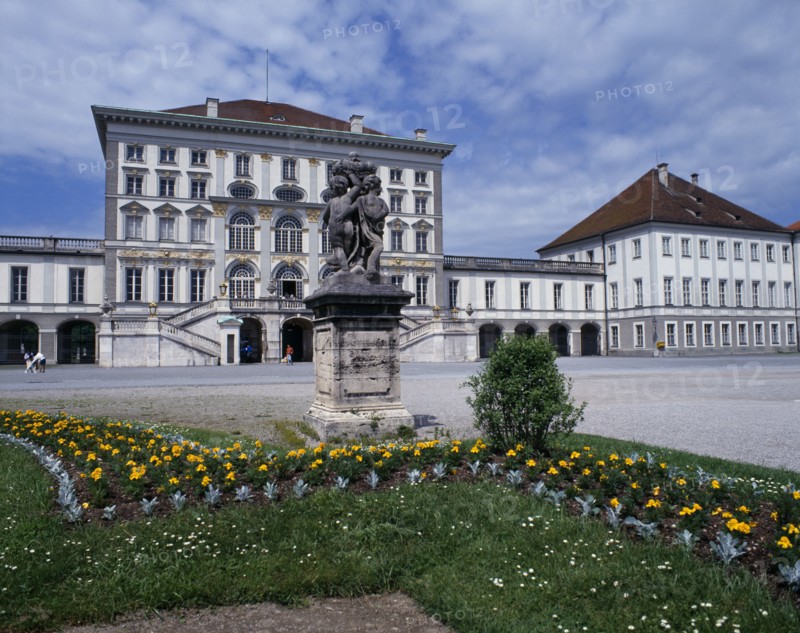 GERMANY, Bavaria, Munich, Nymphenberg Palace. Stone statue on plinth with flower bed in foreground