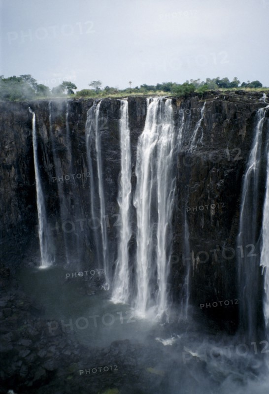 ZIMBABWE, Waterfall, Zambezi River Victoria Falls. Waterfall plummeting 355 feet over a sheer cliff face.