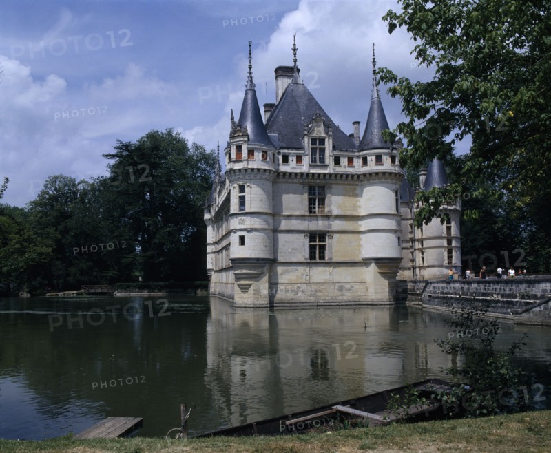 FRANCE, Loire Valley, Azay Le Rideau Chateau and Water filled Moat Bridge Boat Moared On Bank In Foreground