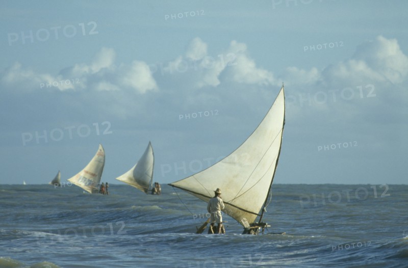 BRAZIL, Ceara, Near Fortaleza, Jangodas going fishing in the early morning choppy seas