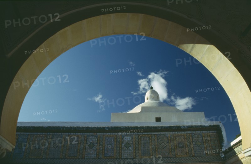 TUNISIA, Kairouan, Mosque dome seen through arch