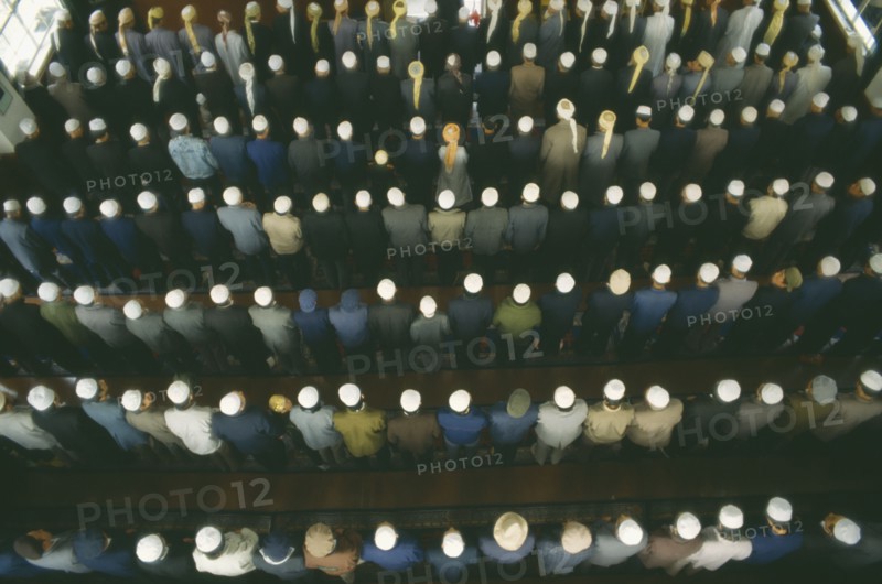 CHINA, Gansu Province, Lanzhou, View looking down on rows of praying Muslims in a Mosque on festival day to mark the end of Ramadan.