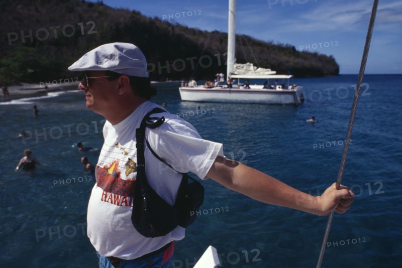 WEST INDIES, St Lucia, Tourists, Tourist taking catamaran tour.