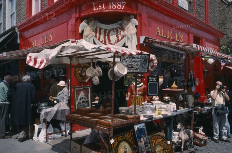 ENGLAND, London, Portobello Road antique shop in the market with a stall outside on the pavement