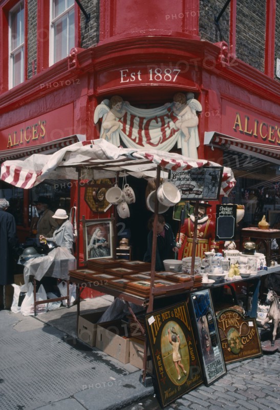 ENGLAND, London, Portobello Road antique shop in the market with a stall outside on the pavement
