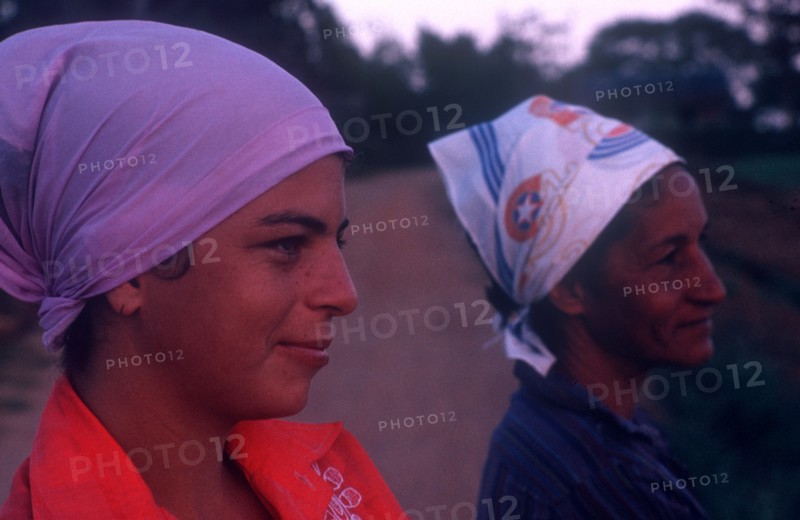 CUBA, Pinar del Rio, Close up of two women wearing head scarfs looking off to the right