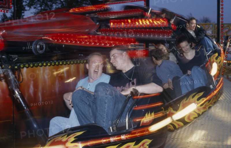 ENTERTAINMENT, Funfair, People on a funfair ride at night with movement blur