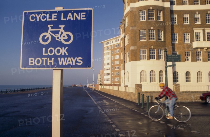 10012731 SPORT  Cycling Cyclist on cycle lane on Hove seafront with sign in the foreground