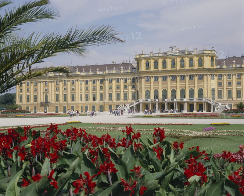 AUSTRIA, Lower Austria, Vienna, Schonbrunn Palace and formal gardens with a bed of red flowers in the foreground