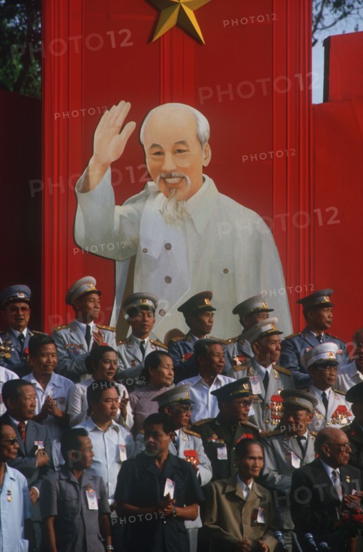 VIETNAM, Ho Chi Minh City , Liberation of Saigon 10th anniversay celebration. Generals standing infront of poster of Ho Chi Minh.