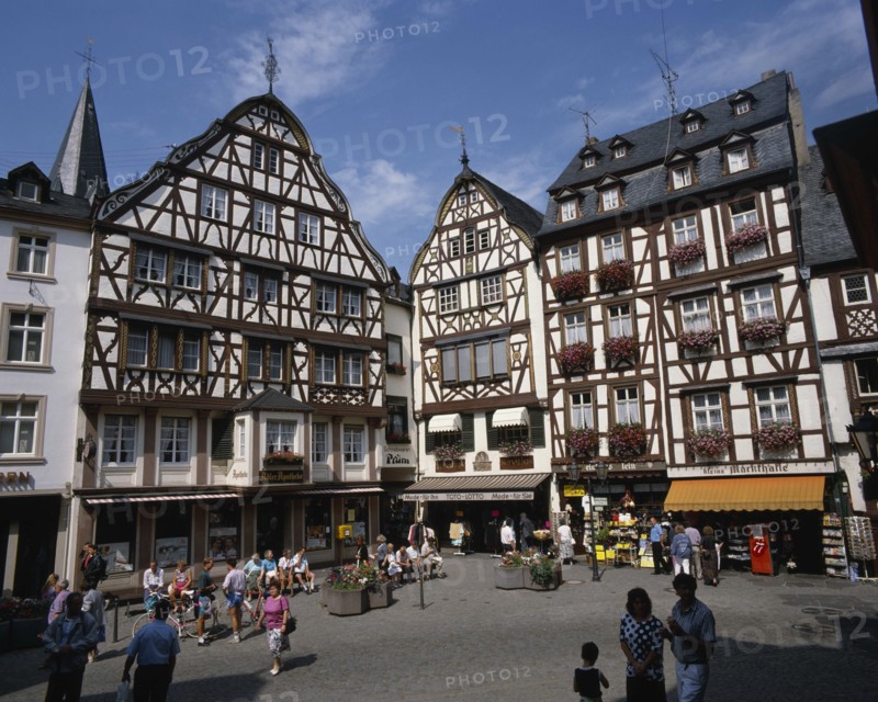 GERMANY, Rhineland, Bernkastel, Town square in the Mosel town. Traditional buildings with people and shops