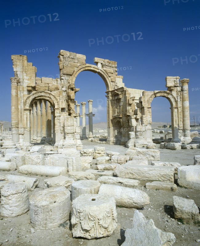 SYRIA, Central, Tadmur, "Palmyra monumental Arch remains, three arches,pillars behind,broken stone. "
