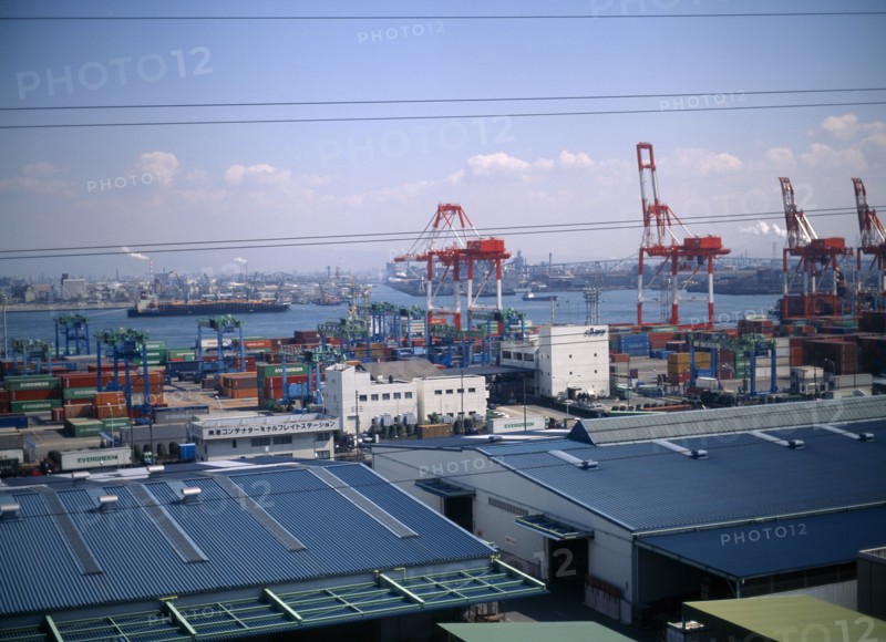 JAPAN, Osaka, Osaka Bay, "Aerial view over the docks with warehouses, containers, cranes and ships. "