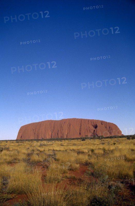 AUSTRALIA, Northern Territories, Ulhuru, Ayres Rock in desert landscape.