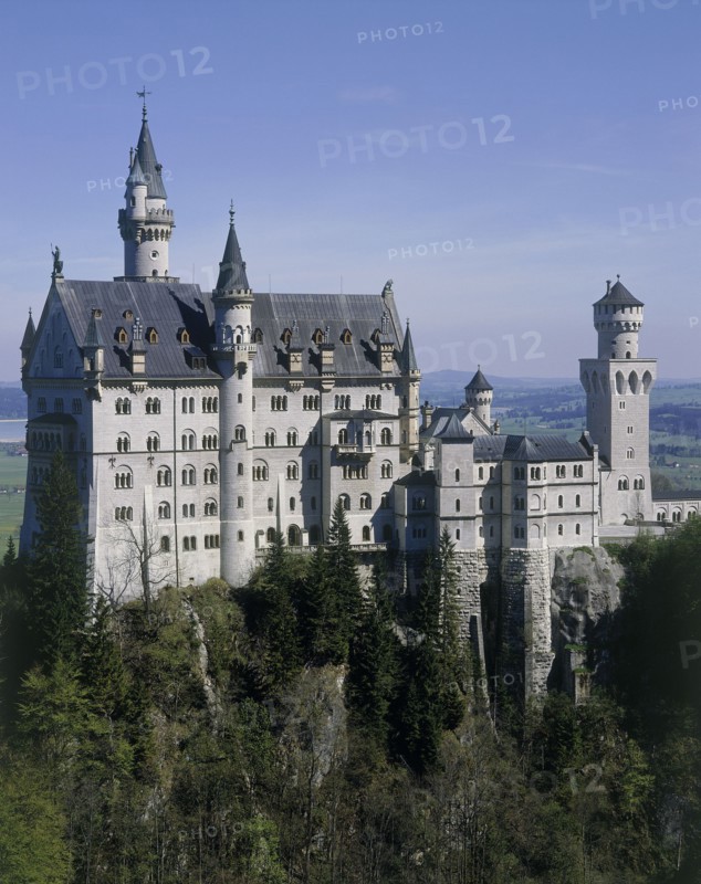 GERMANY, Bavaria, Fussen, Neuschwanstein Castle of King Ludwig on a rocky hill amongst trees