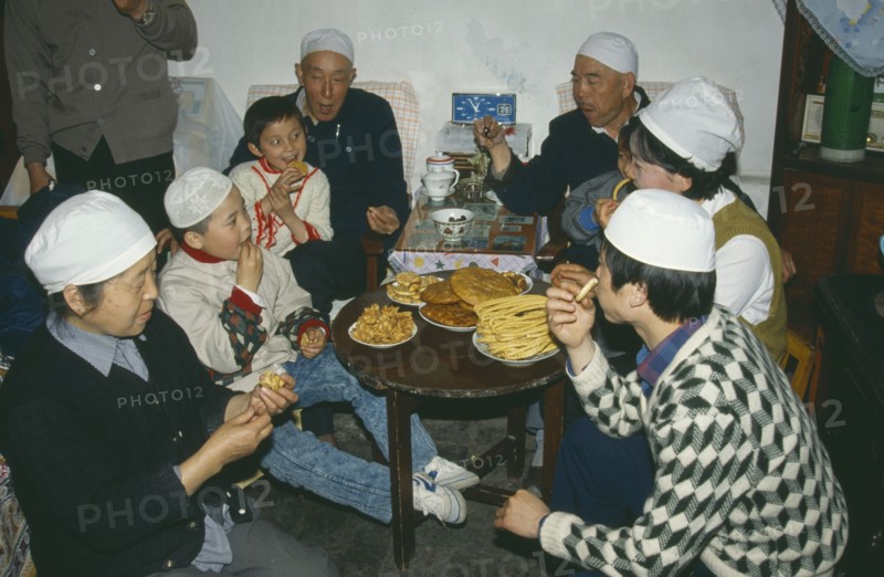 CHINA, Gansu Province, Lanzhou, Muslim family celebrating the end of Ramadan.