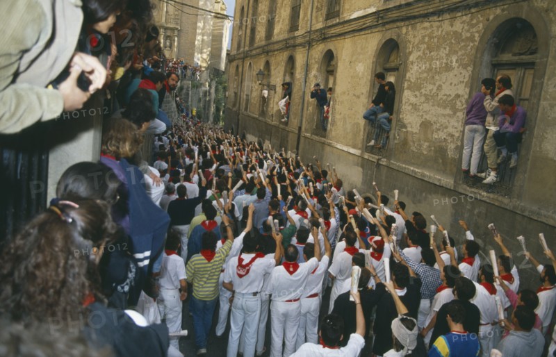 SPAIN, Navarra, Pamplona , San Fermin Bull Run Festival prayers in a narrow street  before bull run begins