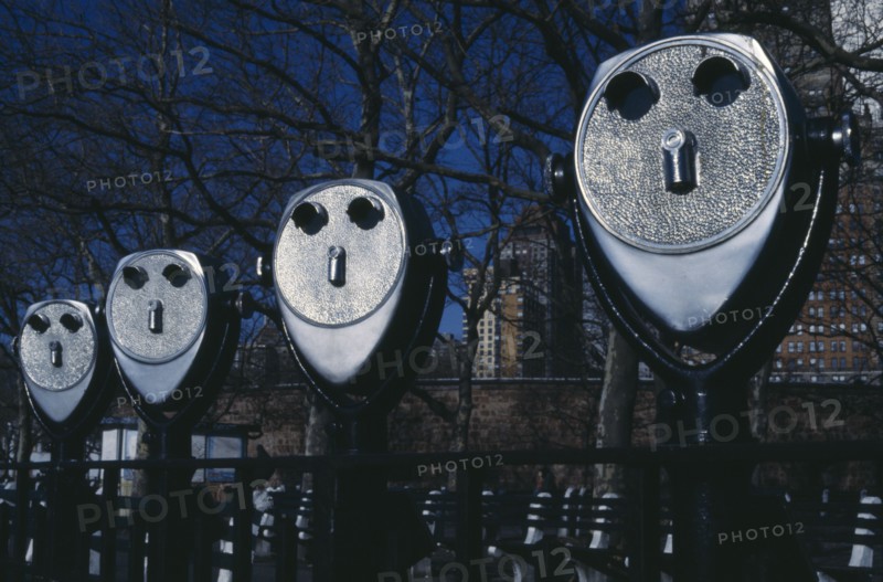 USA, New York, Battery Park, Line of pay binoculars that look like faces