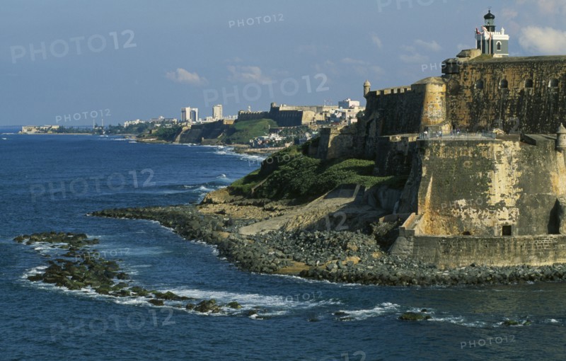 WEST INDIES, Puerto Rico, San Juan, View along San Juan coastline with fort and old city walls.
