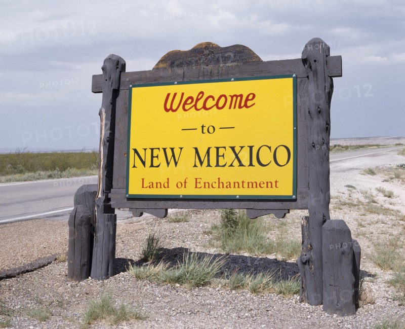 USA, New Mexico, General, Welcome To New Mexico sign in yellow with a wooden surround beside the road