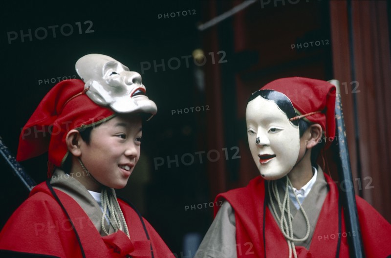 JAPAN, Honshu, Nikko, The Autumn Festival with two young boys dressed in red and wearing white masks