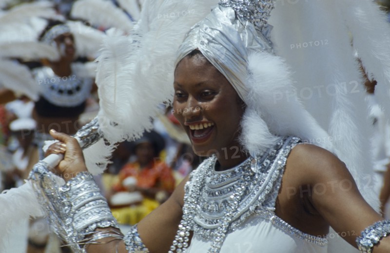 WEST INDIES, Barbados, Crop Over, Woman in silver and white costume at traditional harvest festival to celebrate bringing in the sugar cane crop