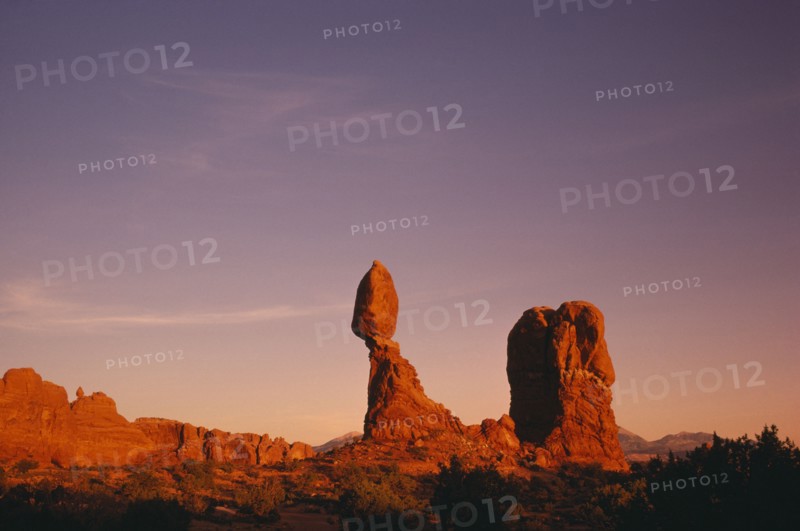USA, Utah, Arches National Park, Balanced Rock formation seen in red evening light