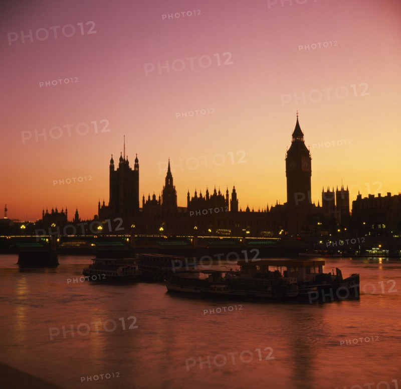 ENGLAND, London, Houses of Parliament & Big Ben at sunset; orange sky.